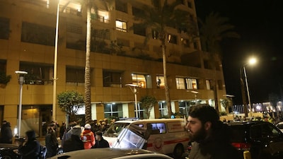 First aid responders gather at a Ramada hotel that was targeted by an Israeli strike, in Beirut’s seaside Rawche area, on March 8, 2026. (AFP)