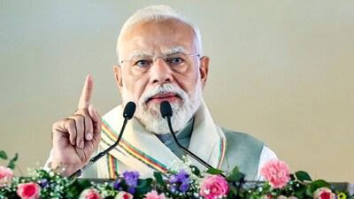 Prime Minister Narendra Modi addresses a gathering during the foundation stone laying and unveiling ceremony of various development works, in Silchar, Assam. (PTI)