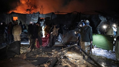 Taliban security personnel carry a body on a blanket at the site of a damaged building after an airstrike hit the Secondary Rehabilitation Services Centre in Kabul on March 16, 2026. (AFP)