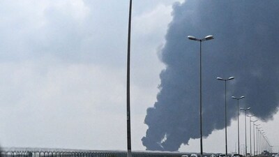 Smoke rises from the area of the Kuwait International Airport after a reported drone strike hit a fuel depot on March 25, 2026. (AFP)
