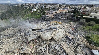 First responders work on the rubble of a building targeted by an Israeli airstrike in the southern Lebanese village of Hanouiyeh, east of Tyre, on March 30, 2026. (AFP)