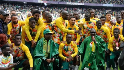 Singer Youssou N'dour, bottom row third left, celebrates with the Senegal team ahead of the international friendly soccer match between Senegal and Peru in Saint-Denis, outside of Paris, Saturday, March 28, 2026. (AP Photo/Aurelien Morissard)
