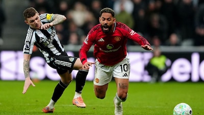 Newcastle United's Kieran Trippier, left, fouls Manchester United's Matheus Cunha during an English Premier League soccer match, Wednesday, March 4 2026, in Newcastle, England. (Owen Humphreys/PA via AP)