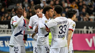 PSG's Nuno Mendes, left, celebrates after scoring the opening goal during the French League One soccer match between Nice and Paris Saint-Germain in Nice, France, Saturday, March 21, 2026. (AP Photo/Philippe Magoni)