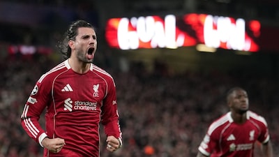 Liverpool's Dominik Szoboszlai, left, celebrates after scoring the opening goal during the second leg of the Champions League round of 16 soccer match between Liverpool and Galatasaray, in Liverpool, England, Wednesday, March 18, 2026. (AP Photo/Jon Super)