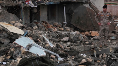 An Iraqi soldier stands looking at the debris as he inspects the site of a destroyed healthcare center (Representative Image)
