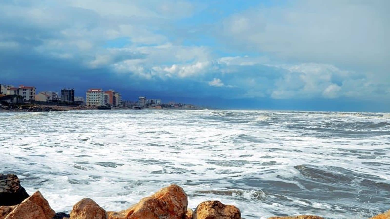 The Caucasus Mountains stand tall along one side of the Caspian Sea. On the opposite side stretch the wide plains of Central Asia, creating a dramatic and varied natural setting.