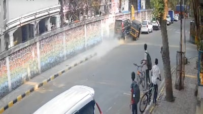 The car hit a young woman walking on the sidewalk. 