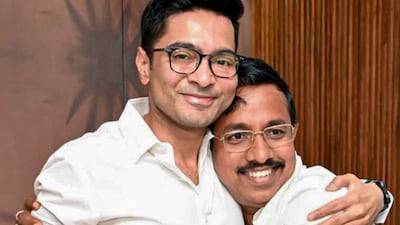 TMC national general secretary Abhishek Banerjee (L) greets former BJP leader Pabitra Kar during his induction into the party at an event, in Nandigram on March 17, 2026. (Image: @AITCofficial/X/PTI)