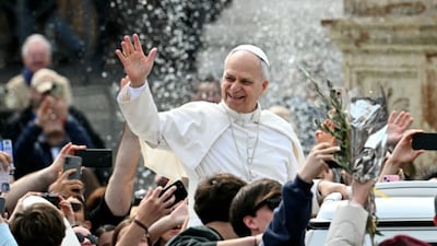 Pope Leo XIV greets the crowd as he leaves after the Palm Sunday mass at St Peter's square in the Vatican on Sunday. (Image: AFP)