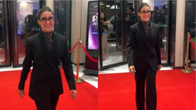 Sanya stepped out in a classic black double-breasted suit, a silhouette that exuded quiet confidence.