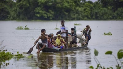 A family stays afloat on a barge as floods grip the state. (Image: PTI)