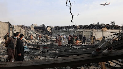 Residents and volunteers inspect the site of a late-Monday airstrike at a drug rehabilitation hospital in Kabul, Afghanistan. (AP Photo)