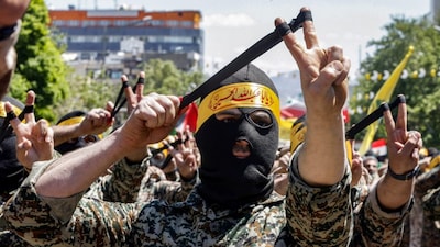 Members of Iran's Basij paramilitary forces aim slings during a rally marking Al-Quds Day, a commemorative day held annually on the last Friday of the Muslim fasting month of Ramadan. (AFP file photo)