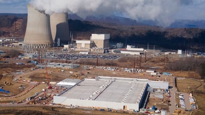 A data centre owned by Amazon Web Services, front right, is under construction next to the Susquehanna nuclear power plant in Berwick. (AP File)