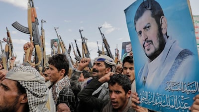 Houthi supporters chant slogans and hold pictures of Abdul Malik al-Houthi, the leader of the Houthi movement, during an anti-U.S. and anti-Israel rally in Sanaa, Yemen, Monday, March 17, 2025. (AP Photo/Osamah Abdulrahman)
