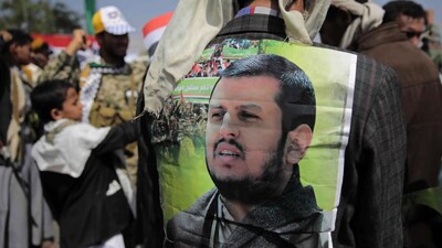 A Houthi supporter displays a poster of leader Abdel-Malek al-Houthi in Sanaa, Yemen. (AP File)