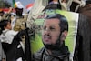 A Houthi supporter displays a poster of leader Abdel-Malek al-Houthi in Sanaa, Yemen. (AP File)