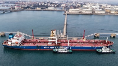 An oil tanker unloads crude oil at a terminal at the port in Qingdao, in China’s eastern Shandong province on March 11. (AFP photo)