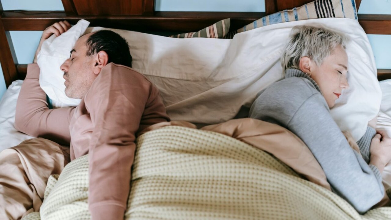 A serene bedroom with two separate sleeping spaces, illustrating the concept of sleep divorce