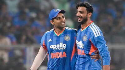 Suryakumar Yadav (left) celebrates the fall of a wicket with teammate Axar Patel. (PTI Photo)