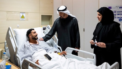 UAE President Mohamed bin Zayed Al Nahyan meets an injured patient receiving treatment at a hospital. (Reuters)