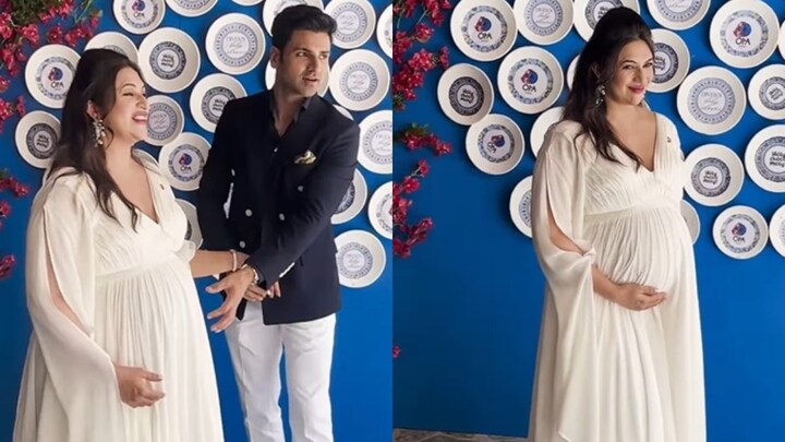 Divyanka Tripathi embracing her baby bump in a white gown during a baby shower celebration