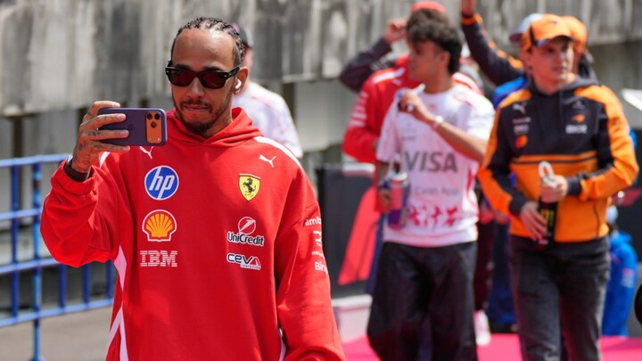 Lewis Hamilton alongside his Ferrari during a race weekend