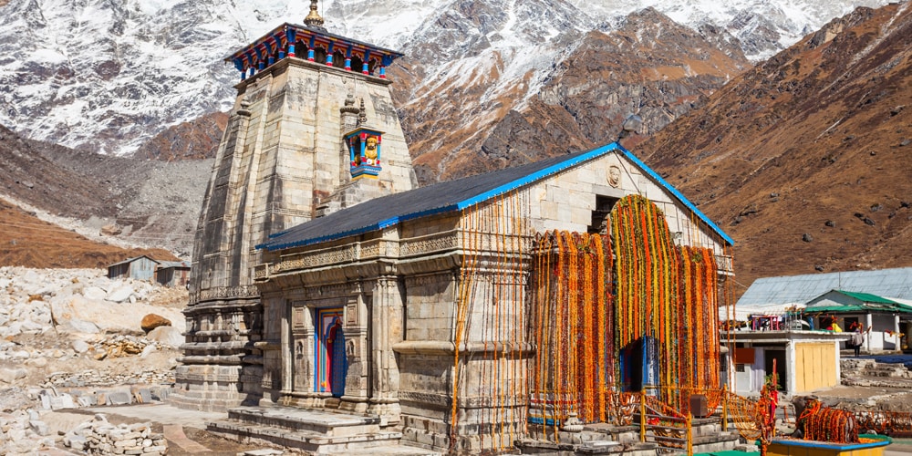  The Peak of Devotion Scheduled to open its gates on April 22, 2026, Kedarnath is perhaps the most dramatic and challenging stop on the circuit. Located on the banks of the Mandakini River and framed by nearly 7,000-meter peaks, it is one of the 12 Jyotirlingas. The temple's atmosphere is charged with a history that dates back to the era of the Mahabharata. Legend says the Pandavas sought Lord Shiva here to ask for forgiveness after the Kurukshetra War. Shiva, taking the form of a buffalo to elude them, dived into the ground, leaving his hump as the primary object of worship at this site. Today, the temple stands as a symbol of endurance, accessible only by a 22-km trek or specialized helicopter services.