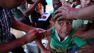 A child reacts while taking measles vaccine through injection at the Jamtoli refugee camp in Cox's Bazar, Bangladesh. (IMAGE: REUTERS FILE) 
