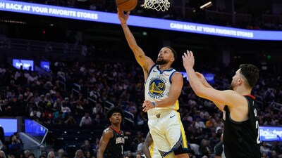 Stephen Curry shoots next to Houston Rockets center Alperen Sengun (Picture credit: AP)