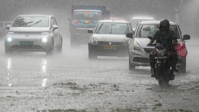 Vehicles ply on a road amid heavy rain, in Kolkata on April 5, 2026. (Image: PTI)