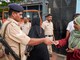 A police personnel checks the ID cards of voters during the Kerala Assembly elections, in Thiruvananthapuram, on April 9. (PTI)