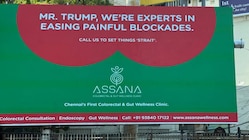 Assana Colorectal & Gut Wellness Clinic billboard with a humorous reference to former U.S. President