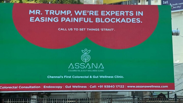 Assana Colorectal & Gut Wellness Clinic billboard with a humorous reference to former U.S. President
