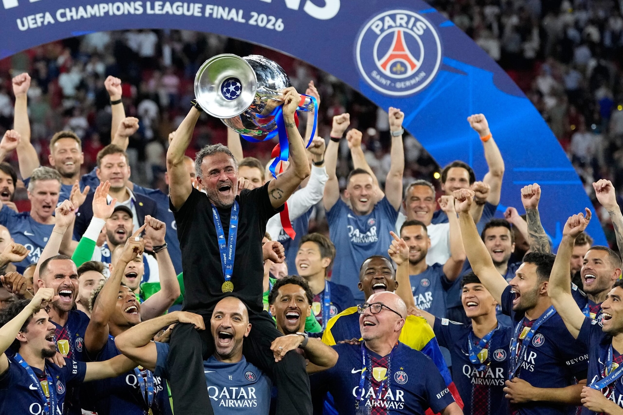 PSG's head coach Luis Enrique lifts the trophy celebrating after winning the Champions League final soccer match between Paris Saint-Germain and Arsenal in Budapest, Hungary, Saturday, May 30, 2026. (AP Photo/Petr Josek)