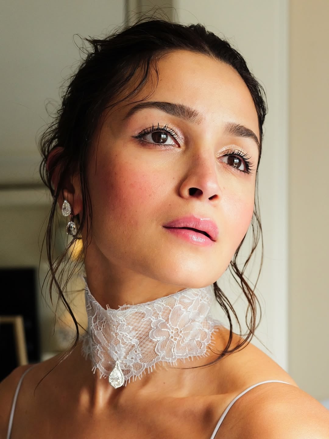 The standout element of Alia Bhatt’s breathtaking red-carpet look was the opulent pendant paired with the lace collar. The sculptural silver head-shaped accessory added a touch of radiance and sparkle to her monochromatic ensemble. (Image: Instagram)