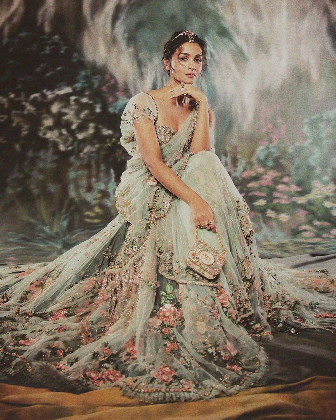 Alia Bhatt: At the Met Gala 2024, Alia Bhatt set the internet abuzz in a custom mint-green sari by Sabyasachi, complete with a dramatic 23-foot train. The ensemble featured intricate floral embroidery crafted with silk floss, glass beads, and semi-precious stones. She styled her hair in a loose updo, adorned with strands of gemstones that echoed the sari’s detailing, and finished the look with statement tourmaline-and-diamond earrings and stacked cocktail rings from Sabyasachi Accessories. (Image: Instagram)