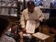An employee shows mangalsutra made of gold to customers inside a jewellery store in the old quarters of Delhi. (IMAGE: REUTERS)