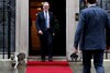 Larry the cat moves away as British Prime Minister Keir Starmer greets French President Emmanuel Macron at 10 Downing Street. (IMAGE: REUTERS) 