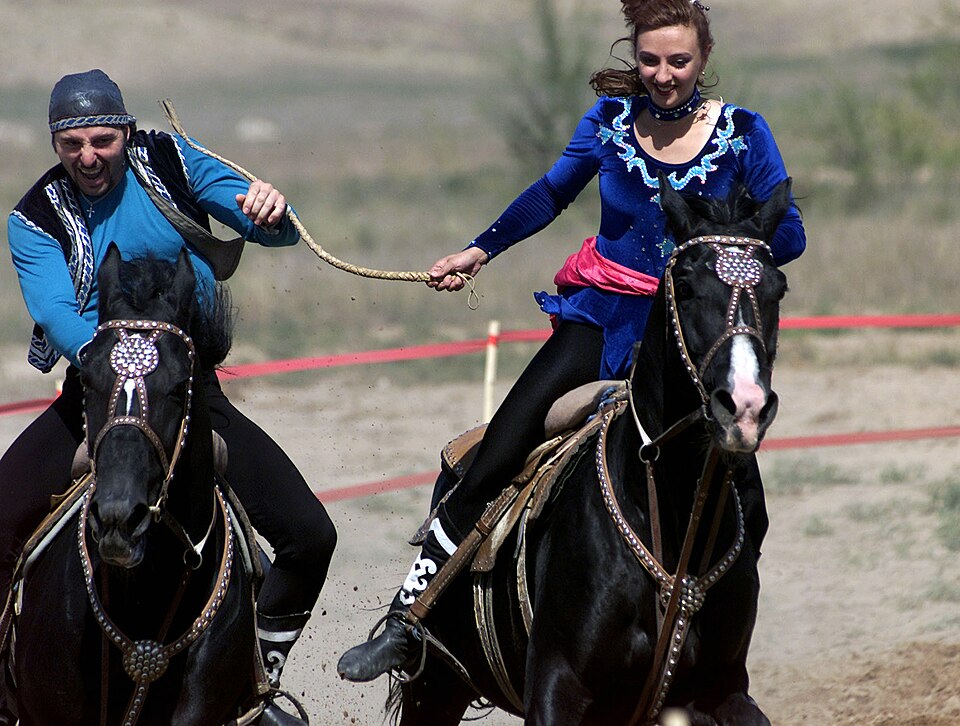 In the heart of Central Asia, dating is not about swiping right or meeting for coffee, it is about how fast you can ride a horse. Kyz Kuu, literally translated as “girl chasing”, is a traditional equestrian game widely played among young lovers in Kazakhstan. (Image: Wikimedia Commons)