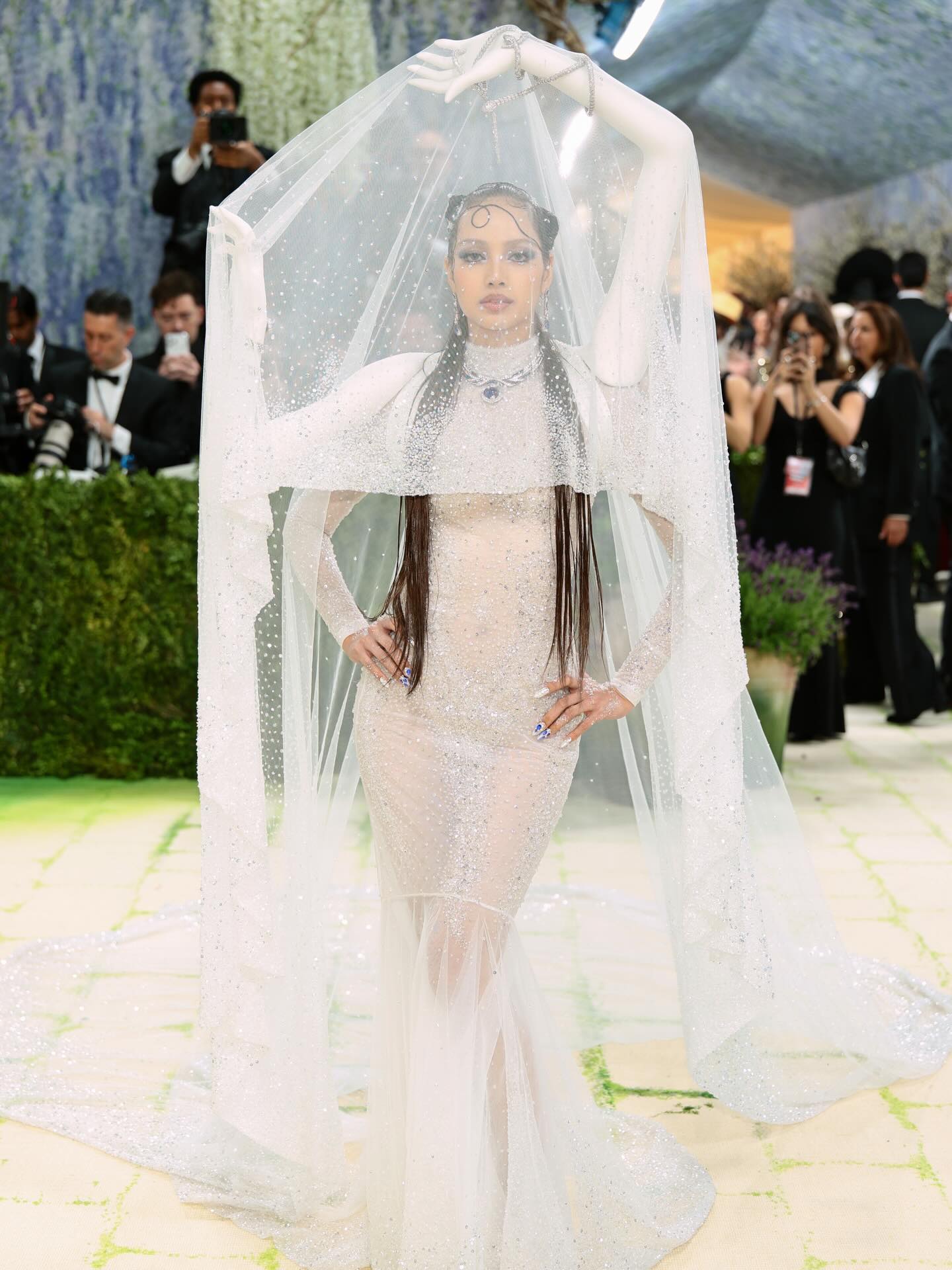 BLACKPINK's Lisa made heads turn in a semi-sheer white gown by Robert Wun that featured her own 3D scanned arms. 