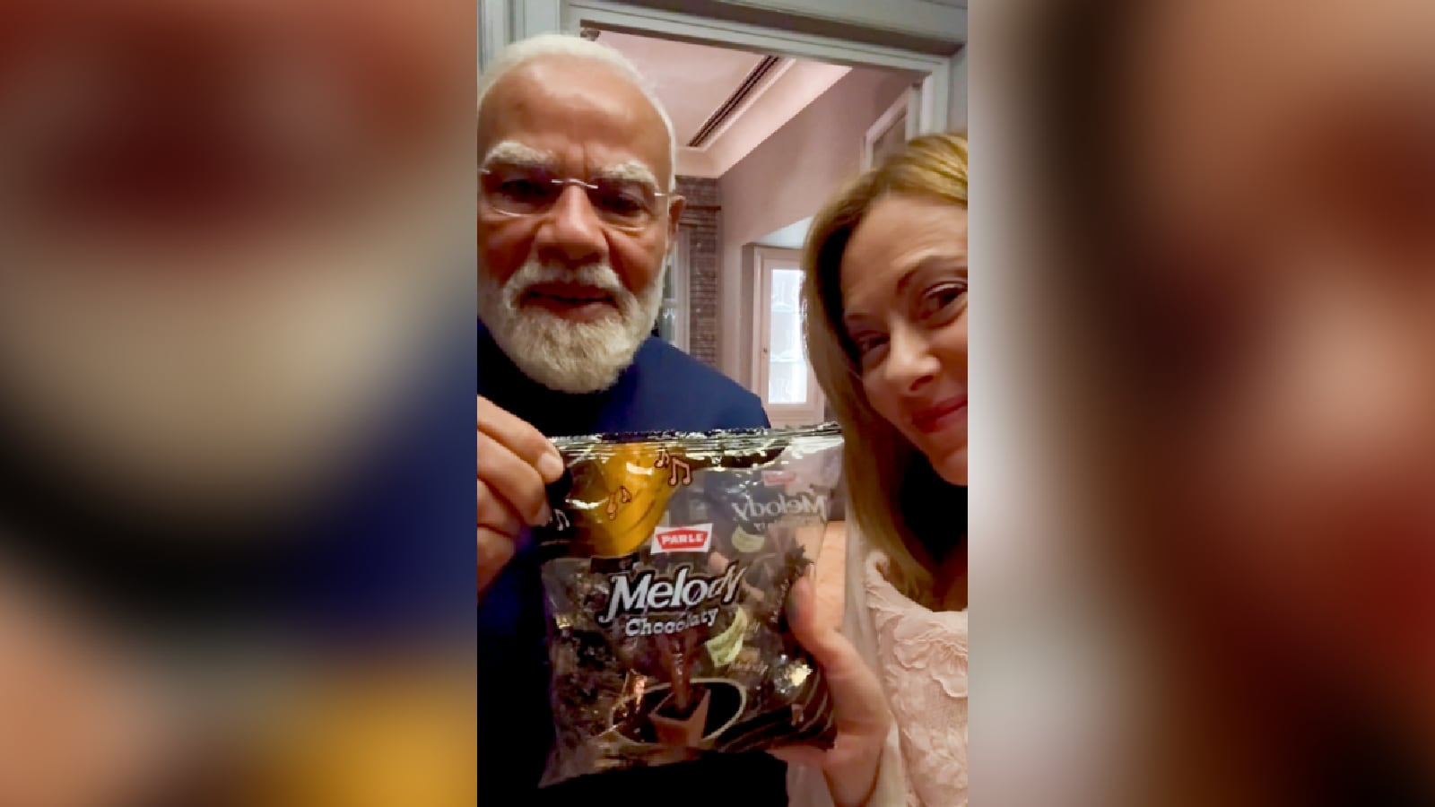 Prime Minister Narendra Modi gifts a pack of toffees to his Italian counterpart Giorgia Meloni during a meeting, in Rome, Italy. (IMAGE: PTI)