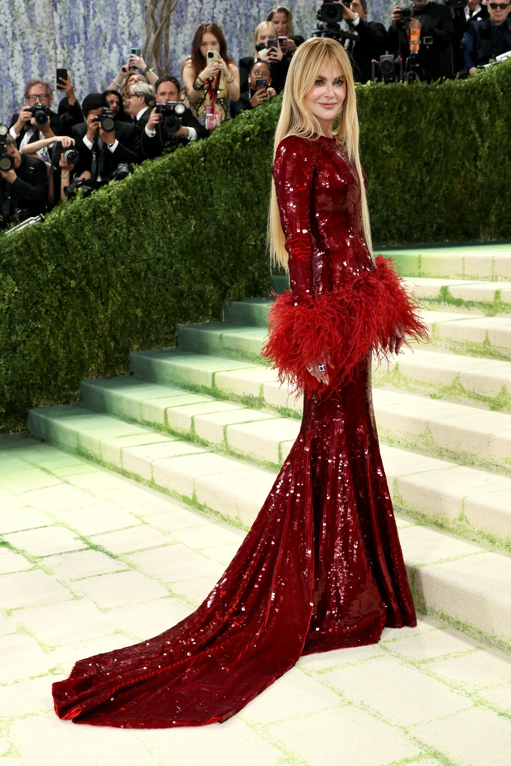 Nicole Kidman, co-chair of Met Gala 2026, sparkled bright in a shimmery red Chanel gown with feather details. 