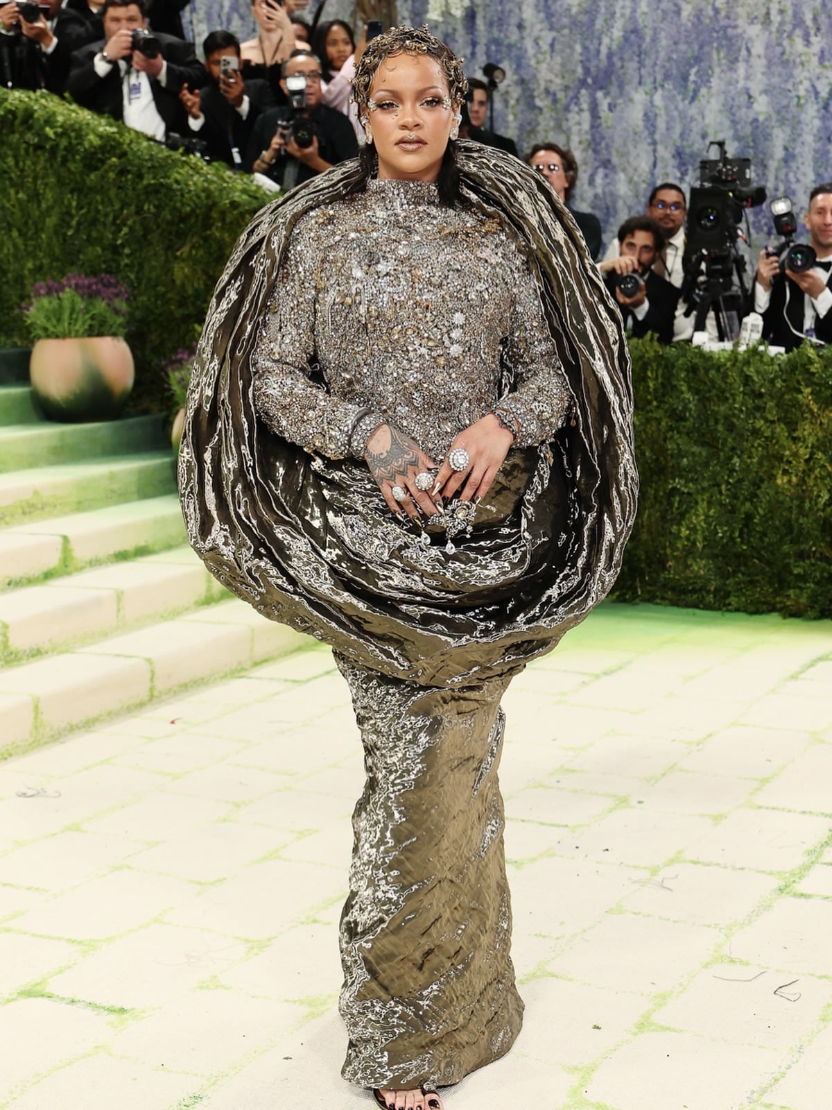 Rihanna aced the theme in a metallic Maison Margiela gown with a draped circular silhouette. 