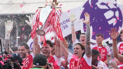 Arsenal players with the PL title. (Picture credit: AP)