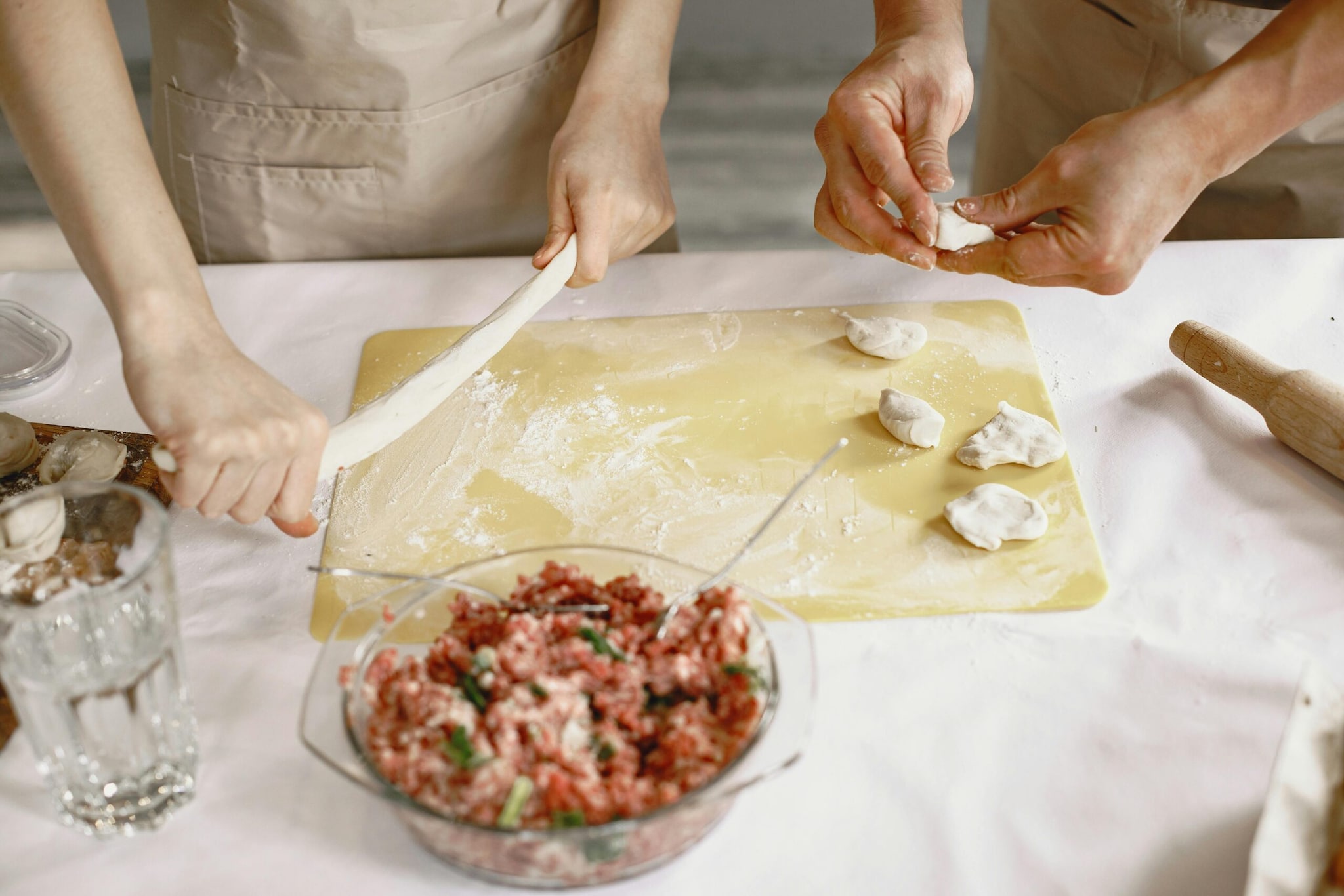  Now, place a small spoonful of the chicken mixture in the centre of a wrapper, fold in the sides, and roll it tightly into a cylinder, sealing the edge with the cornflour paste. 