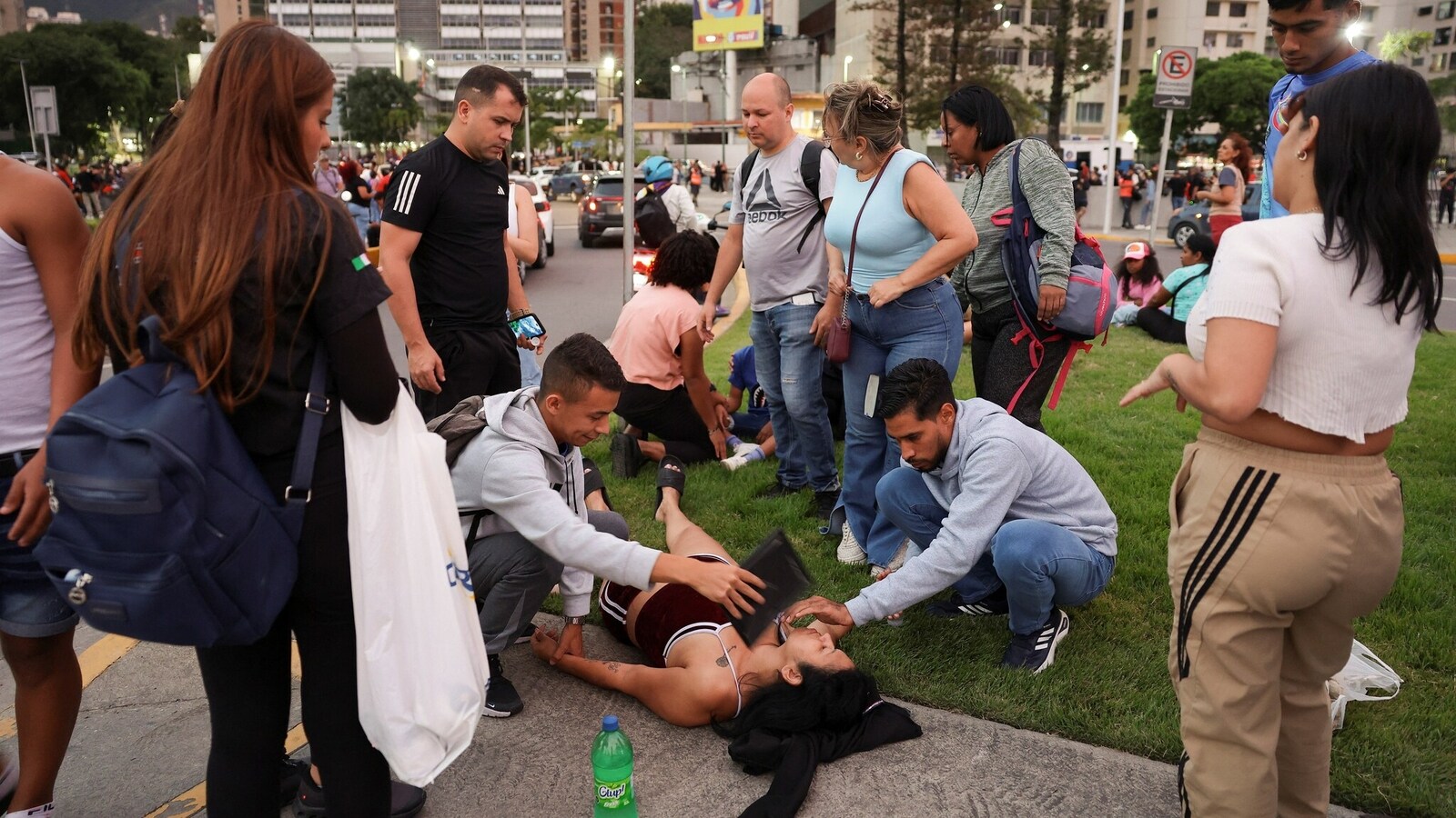 People assist a woman after an earthquake, in Caracas, Venezuela, June 24, 2026. REUTERS/Gaby Oraa