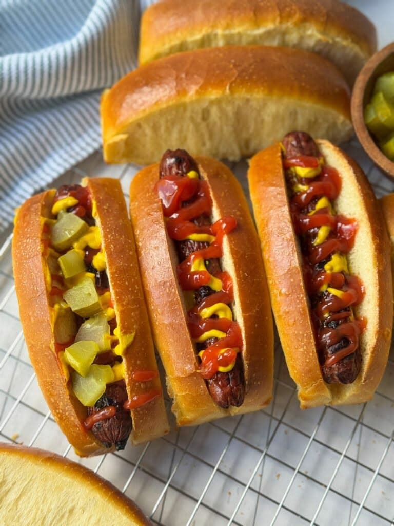  Brush with butter and cool slightly before filing with sausages or favourite toppings.