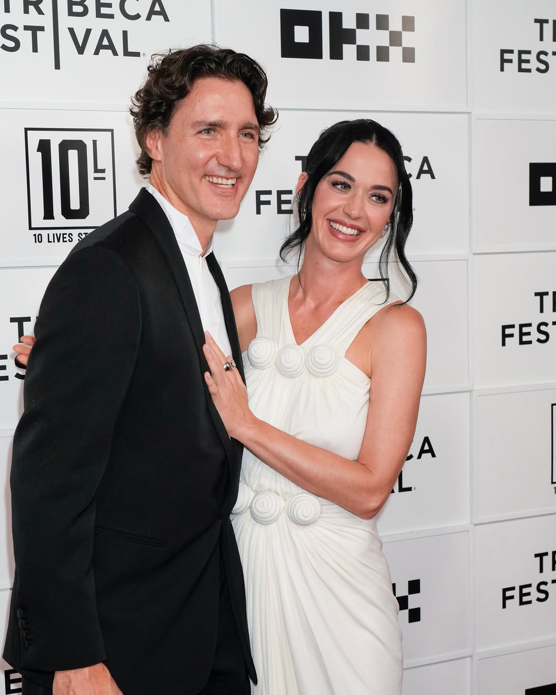  The Lifetimes Tour – Live from Paris. Dressed in a vintage white Lanvin gown, Perry posed alongside Trudeau, who opted for a classic black suit, marking their first joint red carpet appearance as a couple.